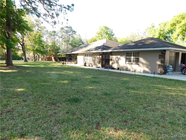 back of property featuring a yard