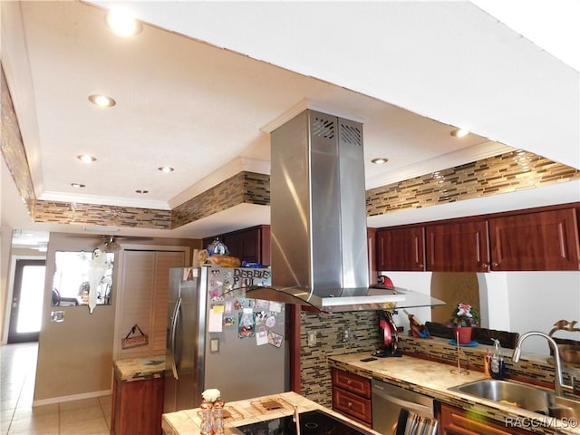 kitchen with sink, island exhaust hood, crown molding, a tray ceiling, and appliances with stainless steel finishes