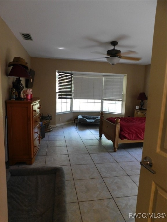 bedroom with light tile patterned floors and ceiling fan