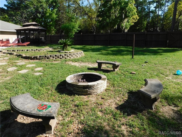 view of yard featuring a gazebo and a fire pit