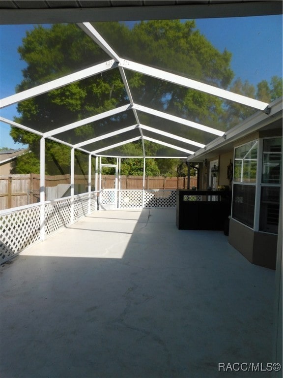 view of patio / terrace featuring glass enclosure