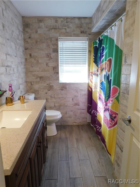 bathroom featuring vanity, curtained shower, toilet, and wood-type flooring