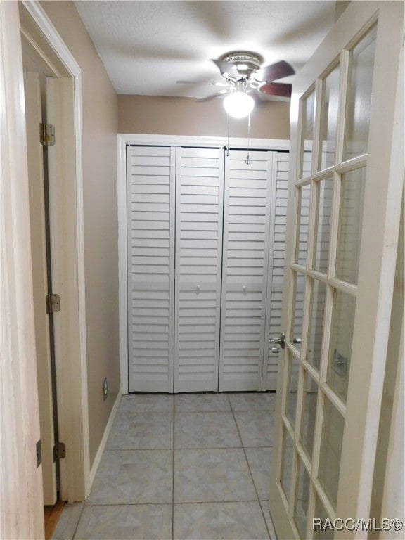 hall featuring light tile patterned flooring