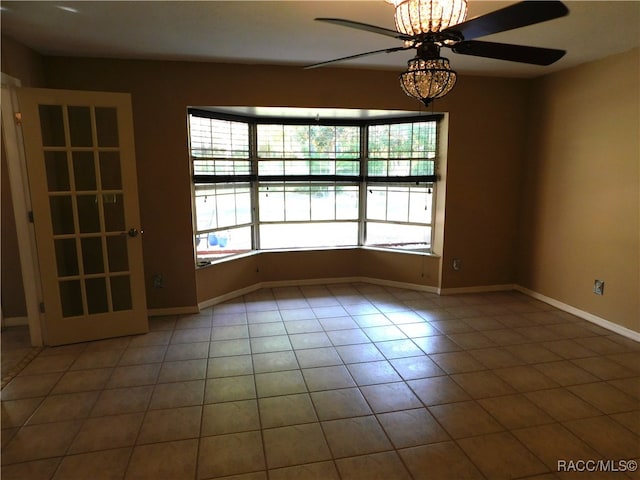 tiled spare room featuring ceiling fan