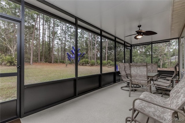 unfurnished sunroom featuring ceiling fan