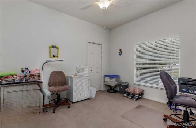 carpeted office space featuring ceiling fan