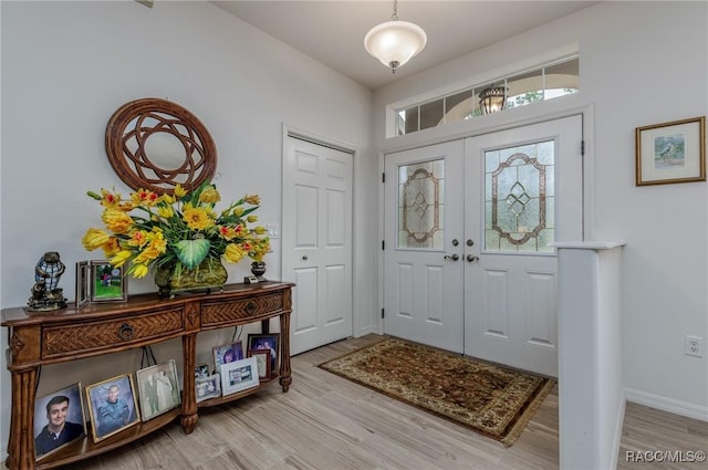 entryway with french doors and hardwood / wood-style flooring