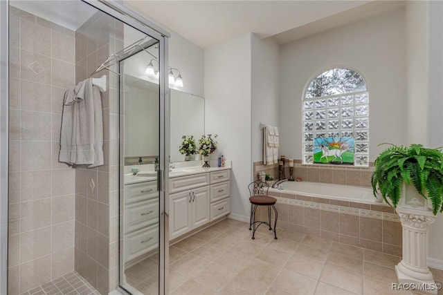 bathroom featuring tile patterned flooring, shower with separate bathtub, and vanity