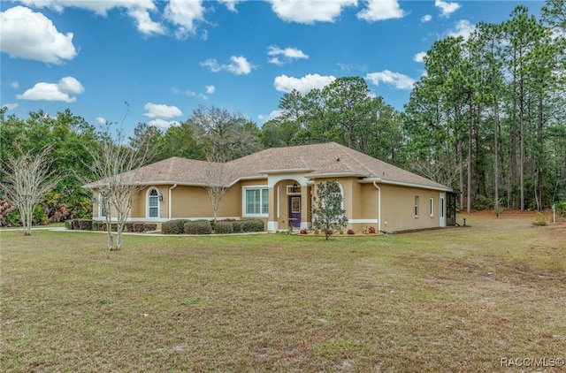 ranch-style home featuring a front yard