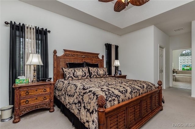 carpeted bedroom featuring connected bathroom and ceiling fan