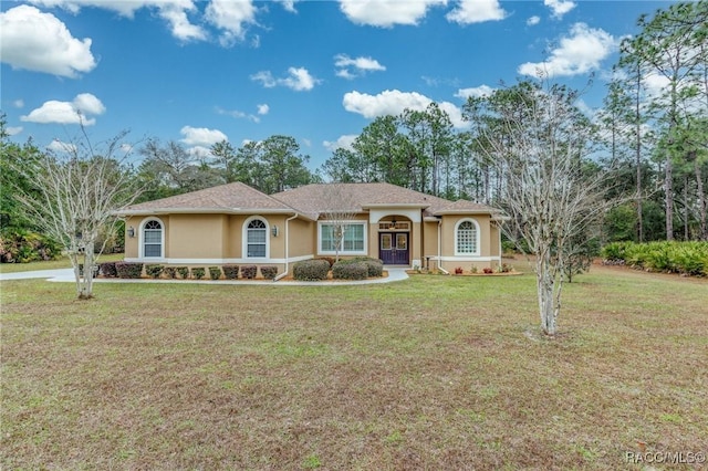 5281 W Cisco St, Beverly Hills, FL 34465 - view of front of house with french doors, stucco siding, and a front yard