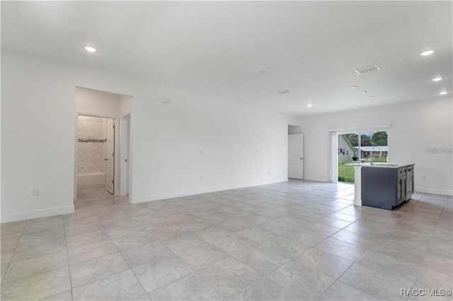 10089 N Athenia Dr, Citrus Springs, FL 34434 - empty room featuring recessed lighting, baseboards, light tile patterned flooring, and a sink