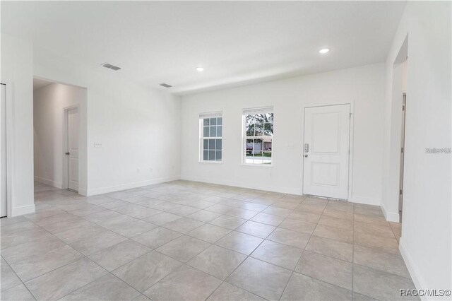 10089 N Athenia Dr, Citrus Springs, FL 34434 - empty room featuring light tile patterned floors, recessed lighting, and baseboards
