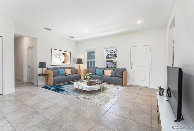10089 N Athenia Dr, Citrus Springs, FL 34434 - living room with recessed lighting, light tile patterned floors, and baseboards