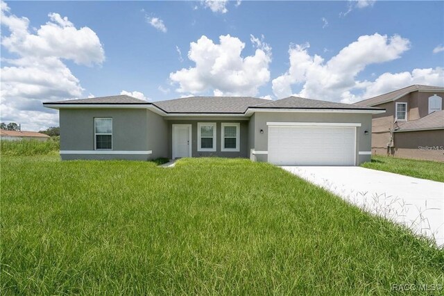 10089 N Athenia Dr, Citrus Springs, FL 34434 - view of front of property with stucco siding, a garage, a front lawn, and concrete driveway