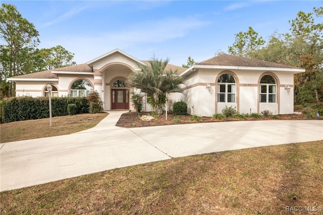 mediterranean / spanish-style house with a front yard