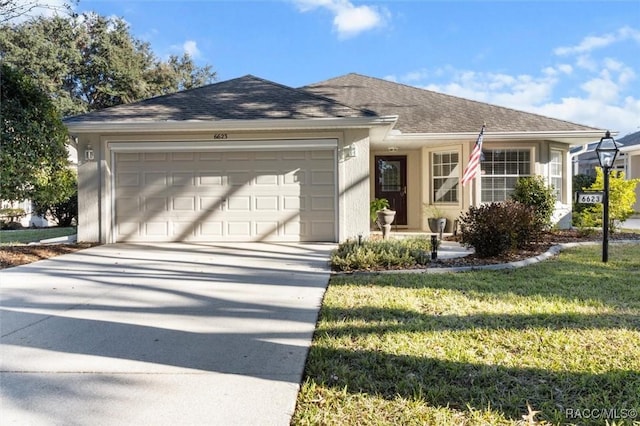 single story home with a front yard and a garage