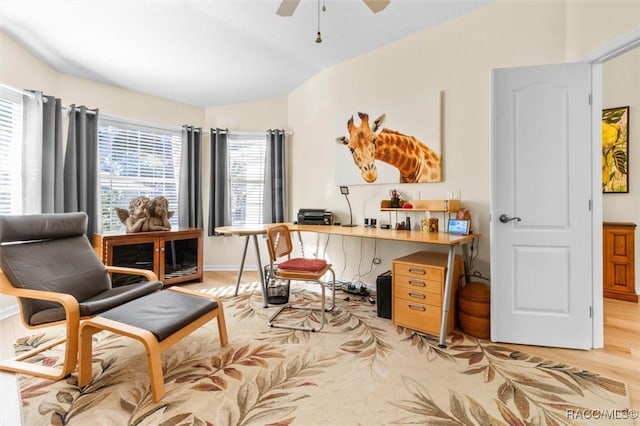 sitting room with ceiling fan, light hardwood / wood-style flooring, and vaulted ceiling