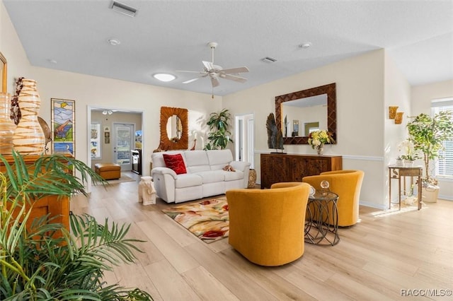 living room with ceiling fan and light wood-type flooring