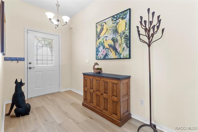 foyer featuring a notable chandelier and light hardwood / wood-style floors