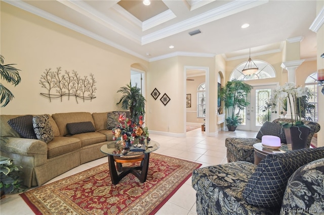 tiled living room with coffered ceiling, crown molding, and french doors