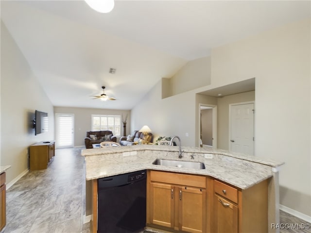 kitchen with sink, light stone counters, vaulted ceiling, black dishwasher, and ceiling fan