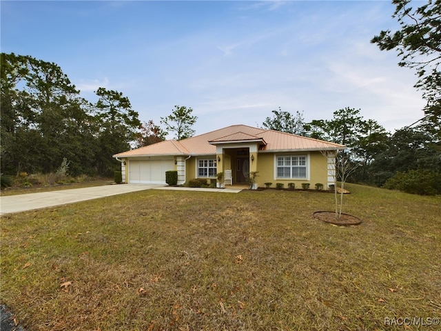 view of front of home featuring a garage and a front yard