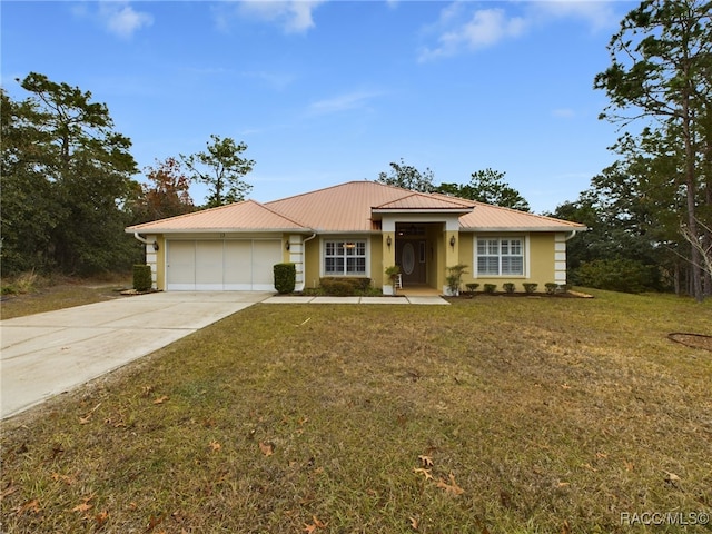 ranch-style home with a garage and a front lawn