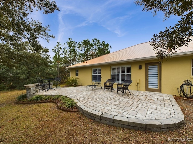 rear view of house with a patio