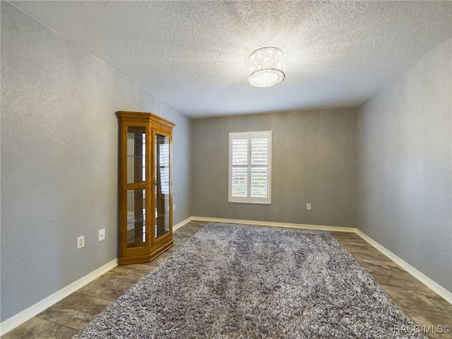 empty room featuring a textured ceiling