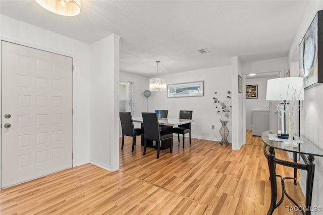 834 E Boston St, Hernando, FL 34442 - dining area featuring light wood-style flooring, baseboards, and a chandelier