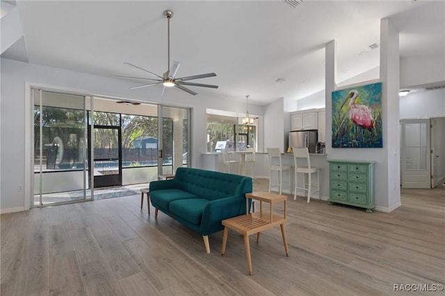 interior space with ceiling fan, light hardwood / wood-style floors, and high vaulted ceiling