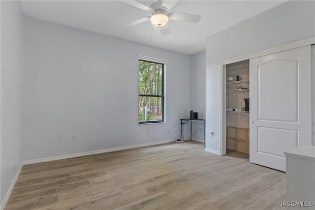 unfurnished bedroom featuring light wood-type flooring, a closet, and ceiling fan