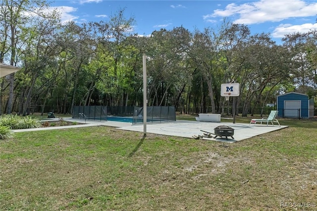 view of basketball court with a yard