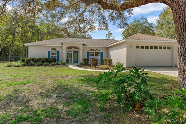 view of front of property featuring a front lawn and a garage