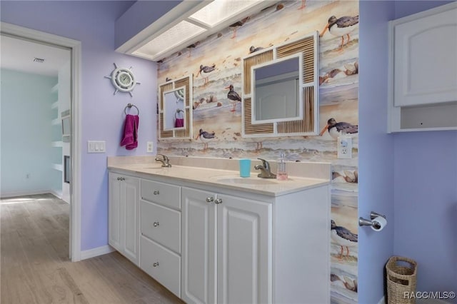 bathroom with vanity and wood-type flooring