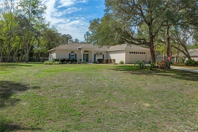 ranch-style house featuring a front lawn and a garage