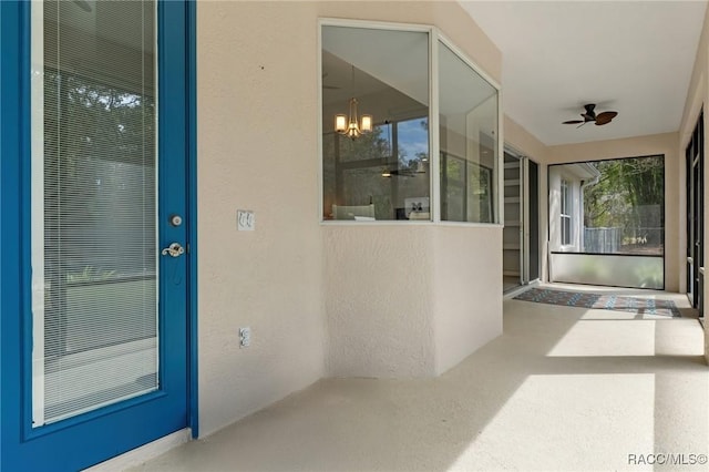 view of exterior entry with ceiling fan