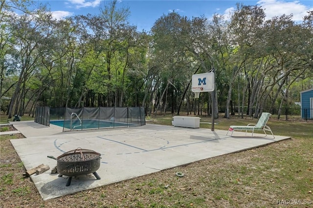 view of sport court featuring a fenced in pool