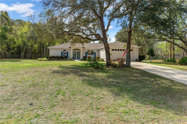 ranch-style house featuring a front yard and a garage