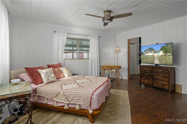 bedroom featuring dark wood-type flooring, wooden ceiling, and a ceiling fan