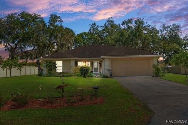 ranch-style house with a yard and a garage