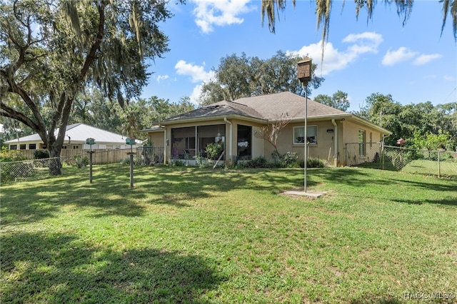 back of property featuring a lawn