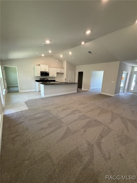 2400 W Tall Oaks Dr, Beverly Hills, FL 34465 - unfurnished living room featuring baseboards, lofted ceiling, light carpet, and recessed lighting
