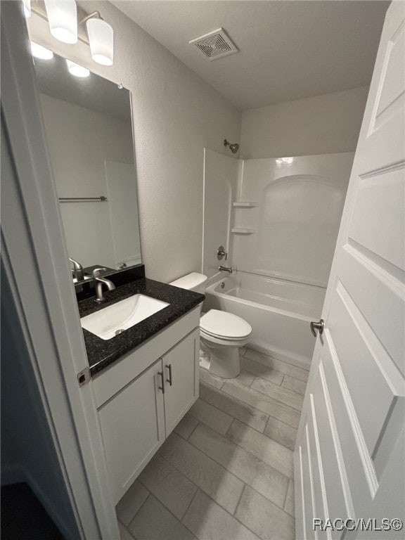 2400 W Tall Oaks Dr, Beverly Hills, FL 34465 - bathroom featuring vanity, toilet, washtub / shower combination, and a textured wall