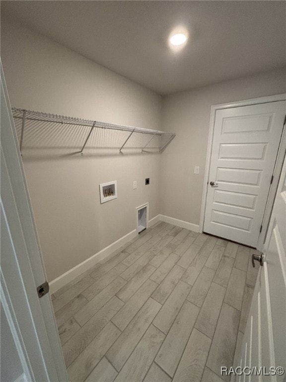 2400 W Tall Oaks Dr, Beverly Hills, FL 34465 - washroom with light wood-style floors, hookup for an electric dryer, washer hookup, and baseboards