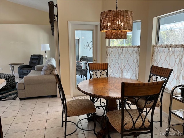 dining room with light tile patterned floors and an inviting chandelier