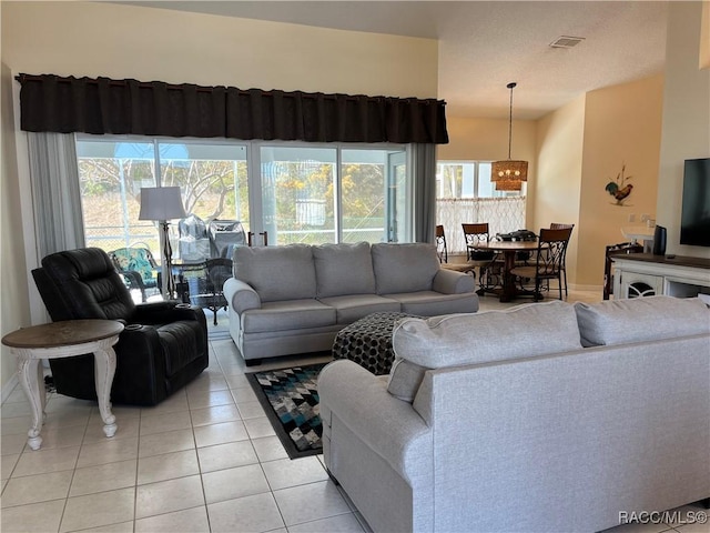 living room featuring visible vents, baseboards, and light tile patterned floors