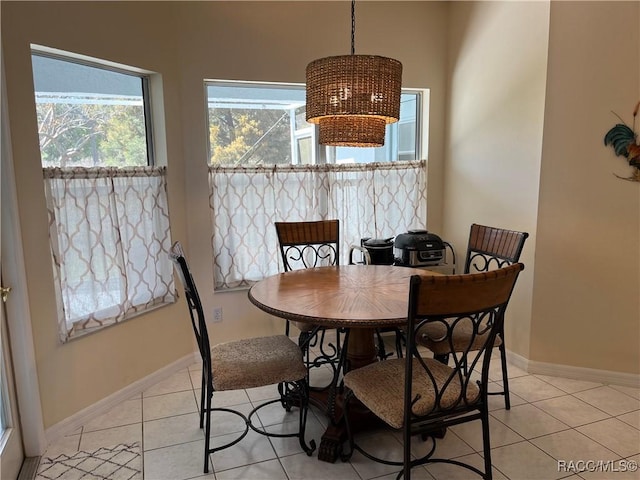 dining space with light tile patterned floors and baseboards