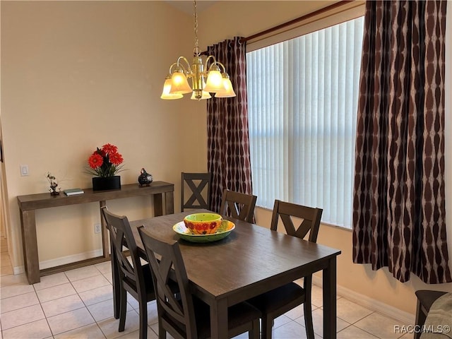 dining room with light tile patterned floors, a chandelier, and baseboards